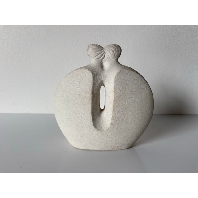 Elegant Art Deco–style marble stone sculpture depicting an abstract couple in an intimate embrace. This beautifully...