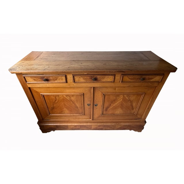 This beautiful mid-19th century Louis Philippe Provincial cherry sideboard features three upper drawers and a two-doored...