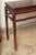 An Elm wood console table with high stretchers and long cornered legs, from China, circa 1850. This table displays the...