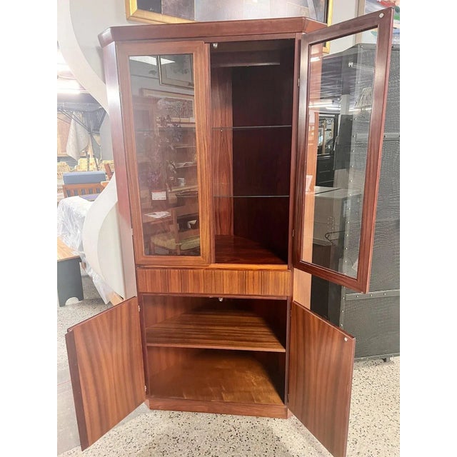Vintage Danish teak corner China cabinet by Skovby. One piece unit with lighted display area at top. A single light at top...