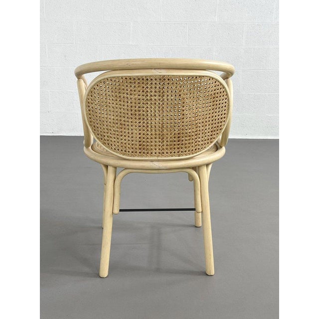 Armchair with a rounded rattan frame, caned seat and back. All in excellent condition.
