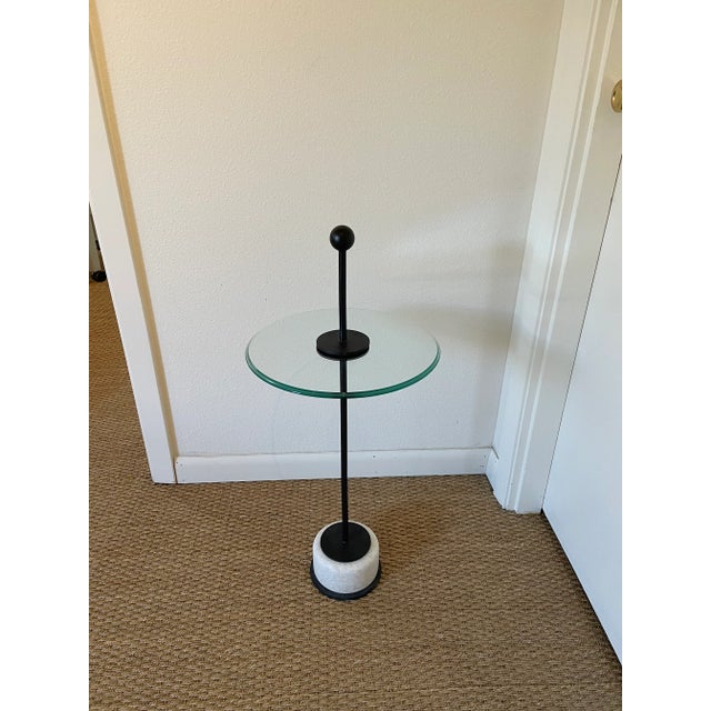 With its slender iron-bar center post, knob grip and stabilizing white marble base, this small round accent or drinks...