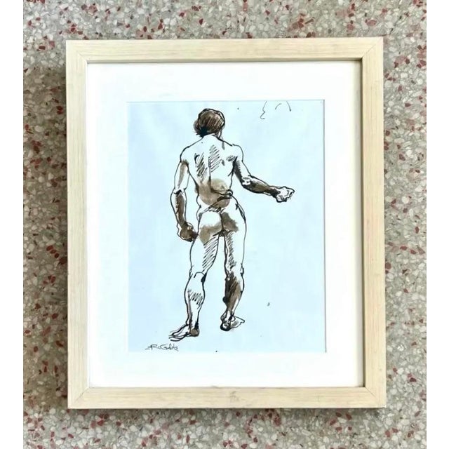 This framed drawing captures the back view of a standing male nude, rendered with loose ink lines and subtle brown washes...