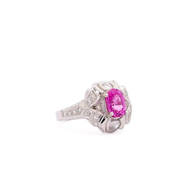 GIA Certified Pink Sapphire and Diamond Ring. Crafted and set in platinum, this engagement ring features a sapphire center...