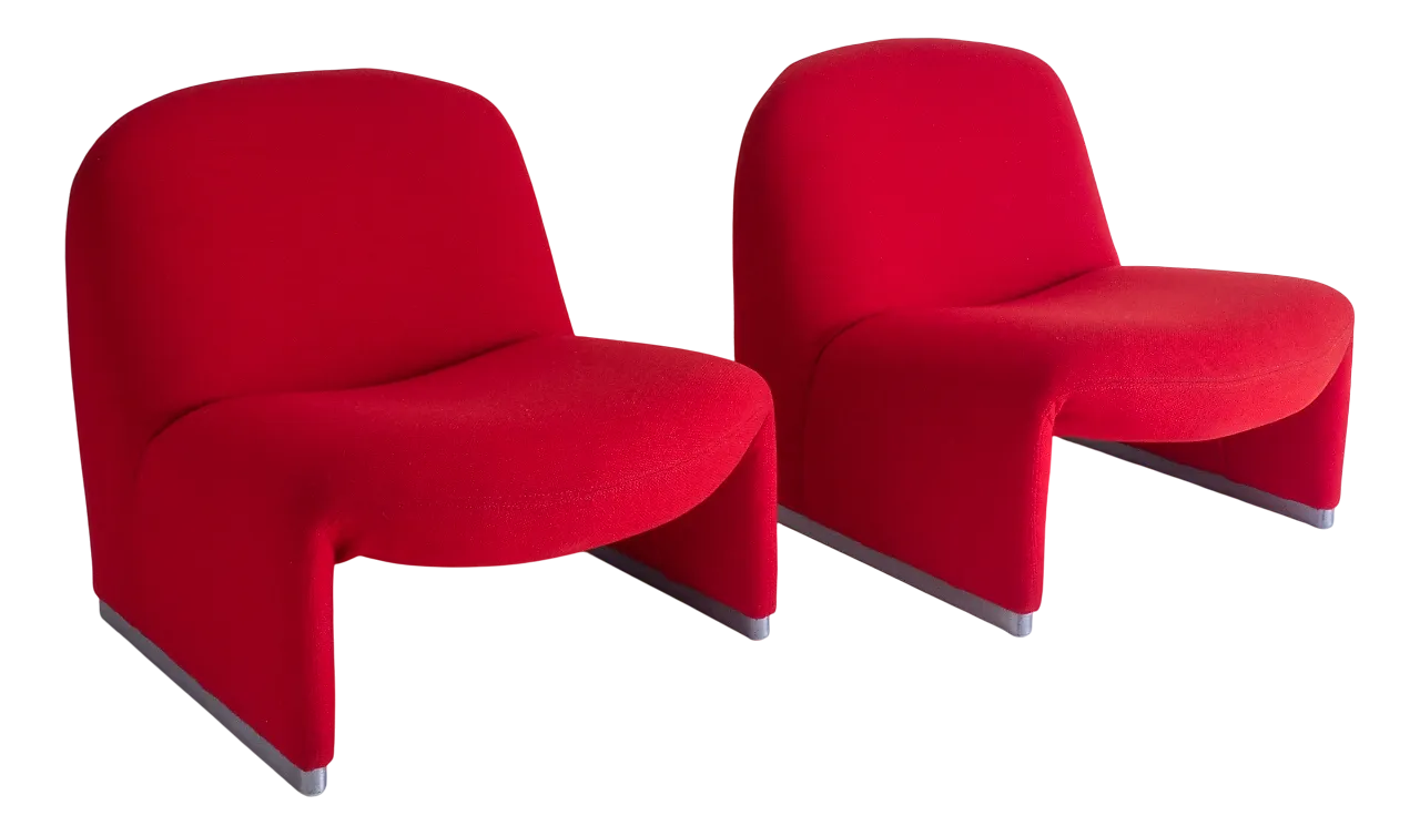 Two red molded chairs side by side on a white background.