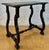 Spanish oak side table dating from the 1920s–1930s. It features a rectangular top with a carved molded edge, elegantly...