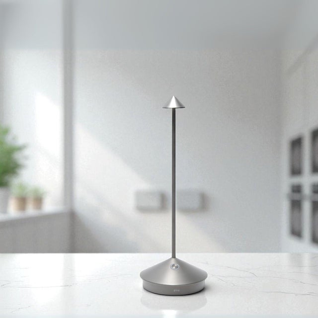 Pina Pro Battery-operated and rechargeable portable table lamp. The lamp features dimming touch control and has 3-CCT...