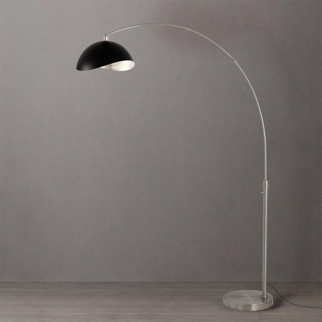 Designed by Peter Morelli in 1960, the Luna Bella Arc Lamp is a modern masterpiece featuring a satin nickel steel body and...