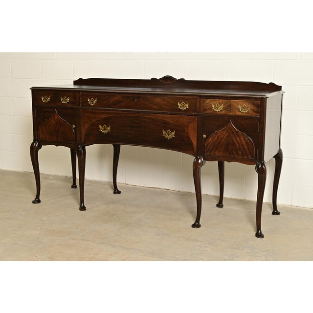 An exceptional antique Chippendale or Queen Anne style sideboard, buffet server, console, or bar cabinet By Charles P....