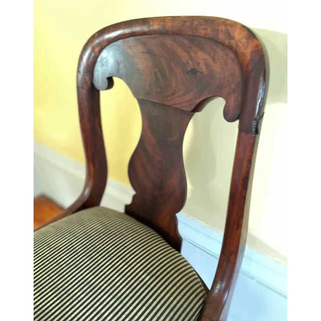 Two antique mahogany Empire side chairs. Two slightly different shapes (please see photos). Chair with rounded back...