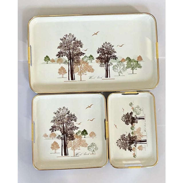 Beautiful set of three vintage lacquerware trays. Each tray has a cream colored base with dark brown tan and olive green...
