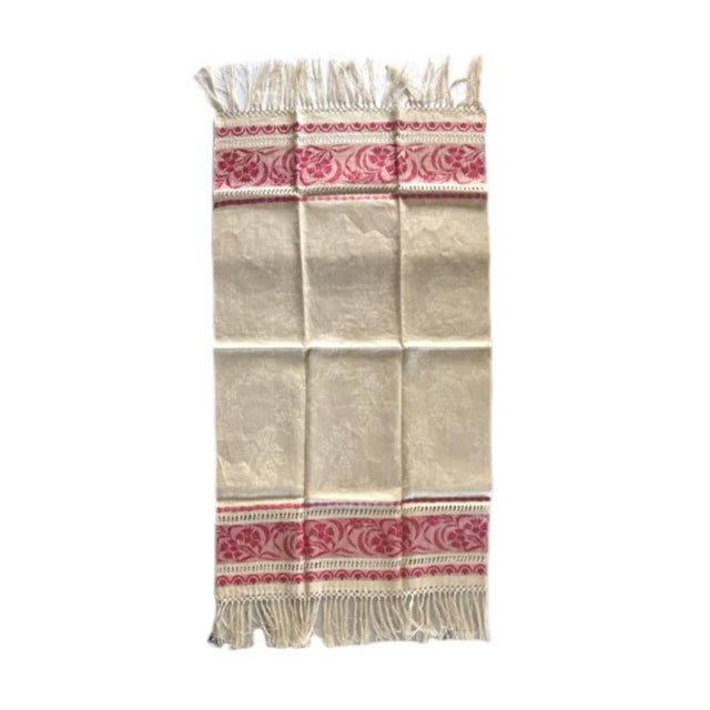 An antique, 19th-century table runner in a woven natural linen with floral damask design and turkey red striped borders...