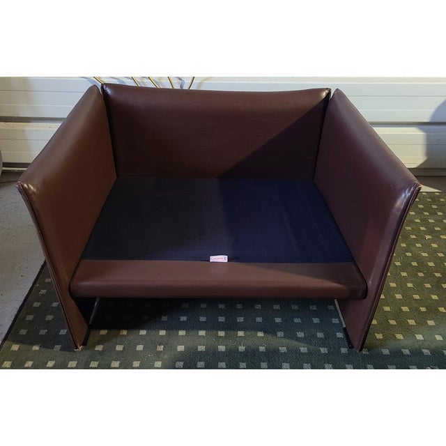Pair of DUC model armchairs in brown leather, designed in the 1970s by Mario Bellini for Cassina. The structure is...