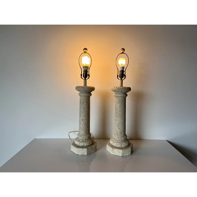 A pair of striking 1980s Vintage Postmodern table lamps crafted in faux-coralstone plaster. Each lamp features a column-...