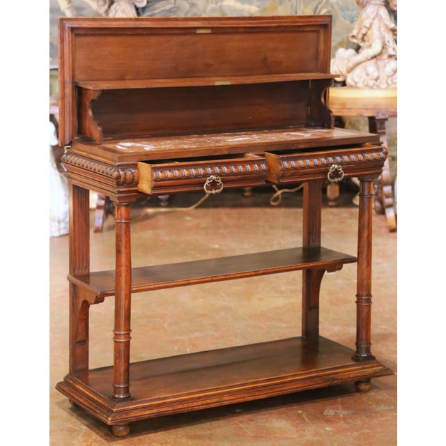 This elegant antique Henri II desserte console was crafted in France circa 1870 and showcases the rich architectural...