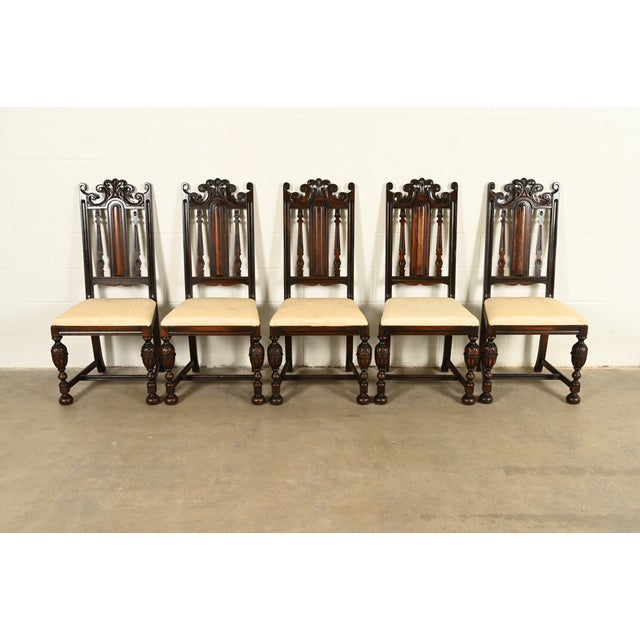 A beautiful set of five antique English Jacobean or Tudor style dining chairs By Berkey & Gay USA, Circa 1920s Carved...