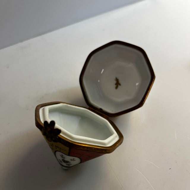 Absolutely charming small geometric red and gold Limoges box with working clasp. Marked Limoges and Peint Main on bottom....