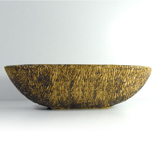 This brutalist platter is made of raw ceramic and decorated with a thick, cracked glaze resembling a sheet of ice. It...
