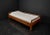 This rare daybed with soul, crafted in Bauhaus design, is made of oak. A double wooden frame encloses three sides of the...