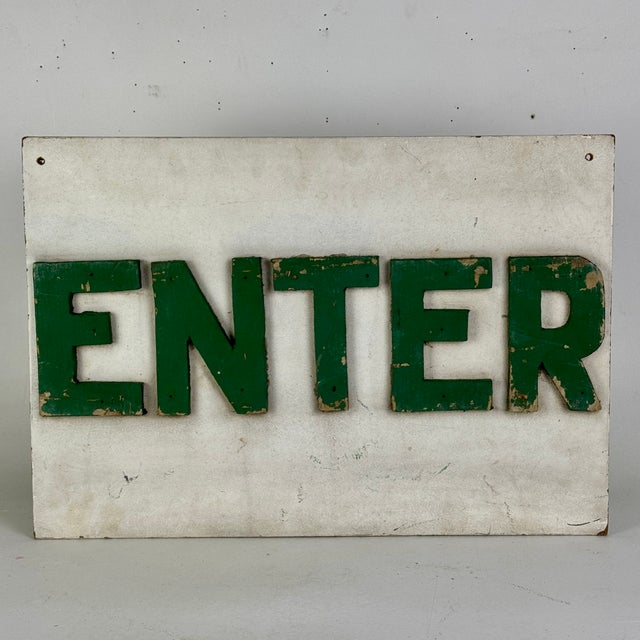 Enter. A beautiful minimalist sign indicating where to enter. Raised letters that have been painted green and placed on a...