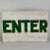 Enter. A beautiful minimalist sign indicating where to enter. Raised letters that have been painted green and placed on a...