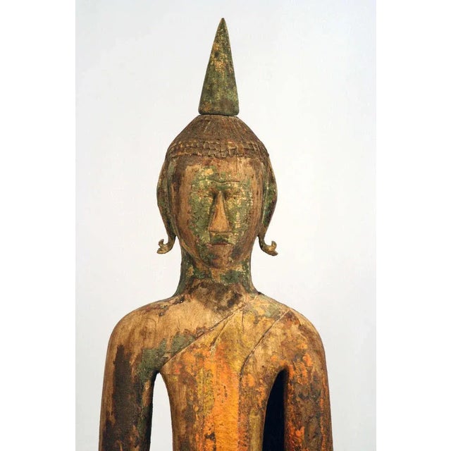 A trinity installation of three antique "village" Buddha from Laos. Carved in an informal village style, the execution of...