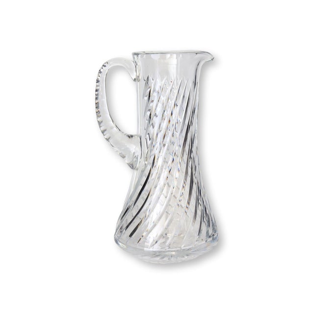 Timeless in both form and function, this vintage crystal beverage pitcher features a graceful swirled cut design that...