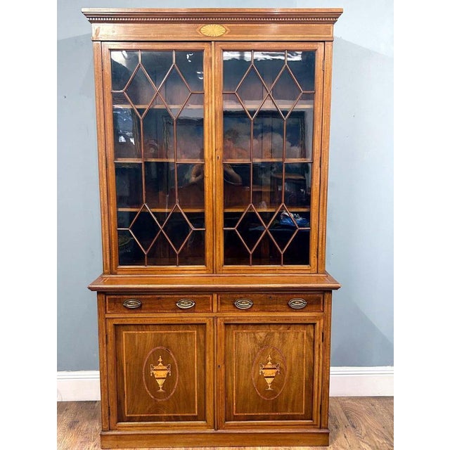 Gorgeous Ewardian bookcase cabinet in mahogany Date 1910 Astragal glazed doors with three interior shelves Features...