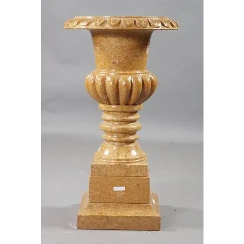 Decorative marble cratervase in the style of classicism Natural marble in golden yellow. Quadrilateral going into curly...