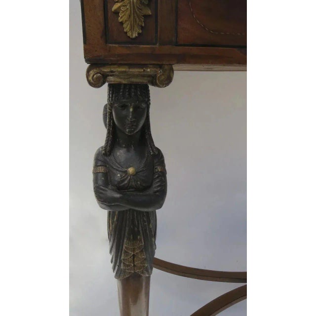 Regency walnut Egyptian table with hoof feet and beautiful terrazzo top with doves motif. Two drawers, four sphinx on each...