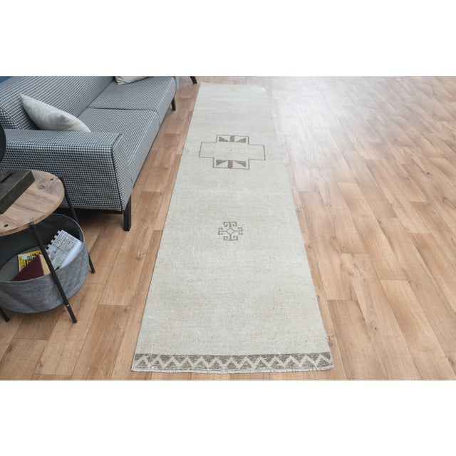 Vintage Hand-Knotted runner rug is a semi-antique vintage area rug. The '70s Eastern region of Anatolia's unique rug is...