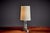 French art deco table lamp by g. Humbert, crafted with a fluted clear glass column, chrome-plated base, and brass details....