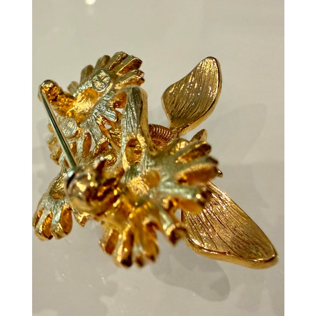 Vintage 1960's enameled purple butterfly brooch on pink and white daisies with clear crystal eyes and body. This unique...