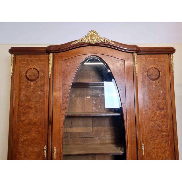 Louis XVI style bookcase cabinet in marquetry circa 1880 opening on the front with 3 leaves, 1 of which has an oval mirror...