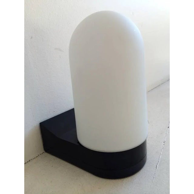 A pair of modernist 1970s German sconces with black PVC frames and white frosted dome glass shades. Rewired.