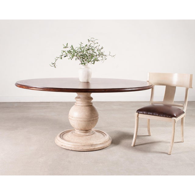 A handsome Ralph Lauren style round inlaid pedestal dining table or center table by Theodore Alexander combining a rich,...