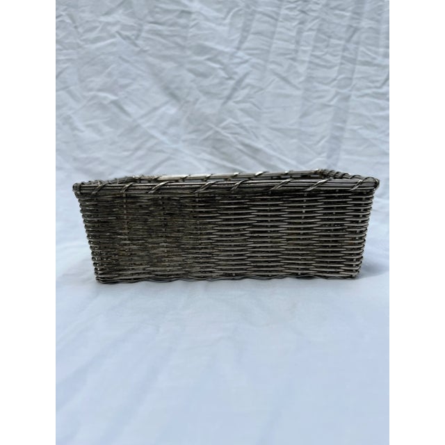 A single rectangle shaped woven silverplate metal bread basket or catchall. This silver basket could be used on a vanity,...
