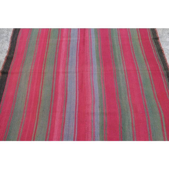 Hand-woven in wool circa 1950-1960, this 5x5 square vintage Peruvian Kilim—traditionally known as a Frazada—is a luminous...