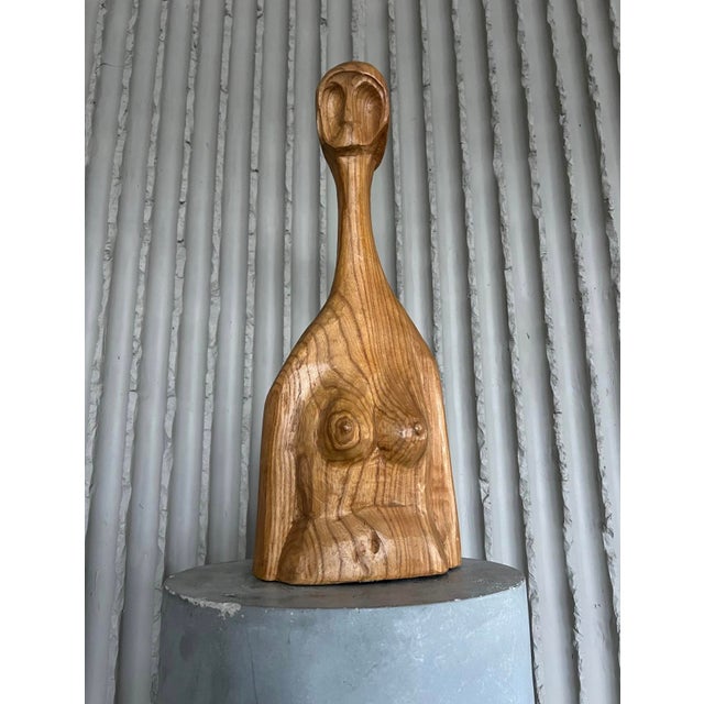 Designer unknown belgium 1960s h 60cm w 25cm d 10cm carved from a single block of richly grained wood, this striking...