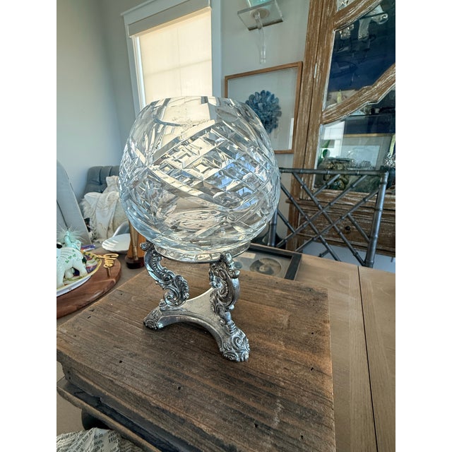 Lovely baroque silver plate stand with a crystal rose bowl sitting atop the stand. The stand is marked Godinger. The bowl...