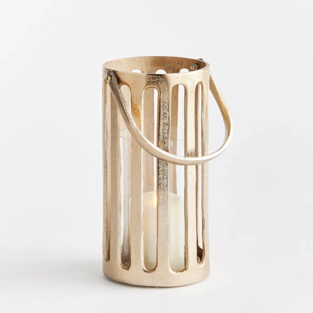 This cast aluminum hurricane in a champagne gold finish has a great presence. Strong and sturdy, it makes a solid accent....