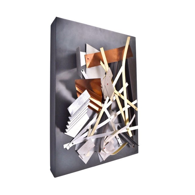 Unique artist made wall sculpture, featuring an array of different strips and pieces of metals skillfully riveted together...