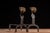 Pair of antique figural fireplace andirons constructed from forged and hammered iron. Each upright standard terminates in...