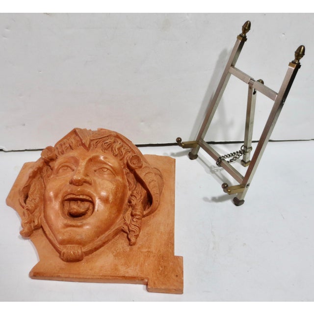 Building tile in heavy, solid terra cotta, with a face of the character Puck. Designed for architectural installation or...