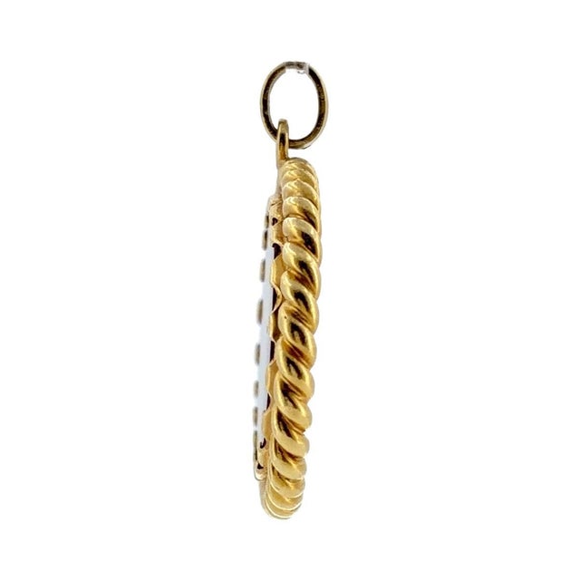 Vintage 18K yellow gold large oval pendant featuring a lion motif intaglio engraved on a carnelian stone, set in a rope...
