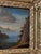 A charming 18th-century Dutch painting, oil on wood panel, depicting a lively village scene by the water in a mountainous...