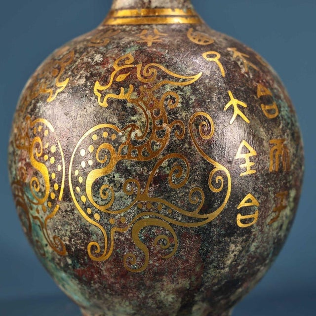 This is an exquisite pair of vintage Chinese bronze vases featuring intricate gold inlay (cuo jin) and silver-toned wire...