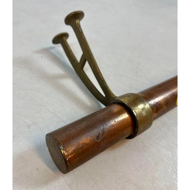 Heavy copper tubing foot rest rail, it has two adjustable brass floor mount brackets. Patina is wonderful, perfect for an...
