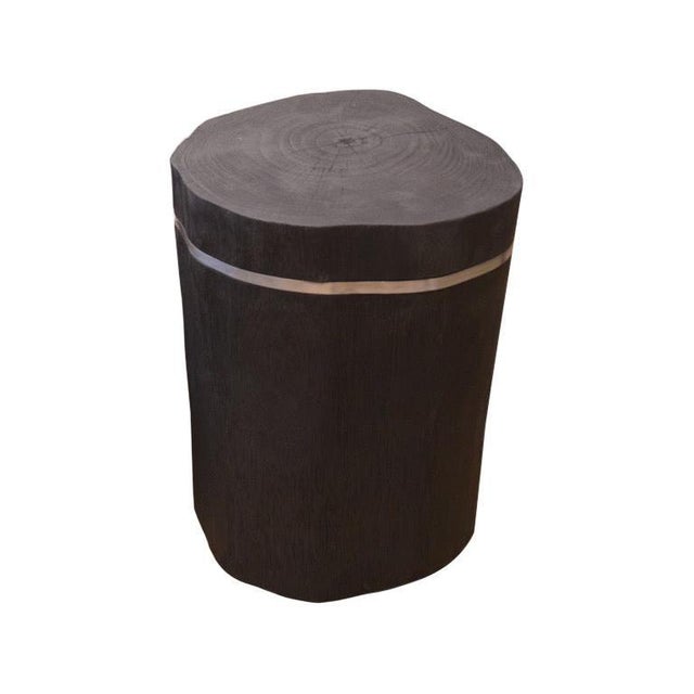 Solid cylinder reclaimed teak side table. Burnt, sanded and sealed with a smooth finish. 1 cm thick silver strip is...