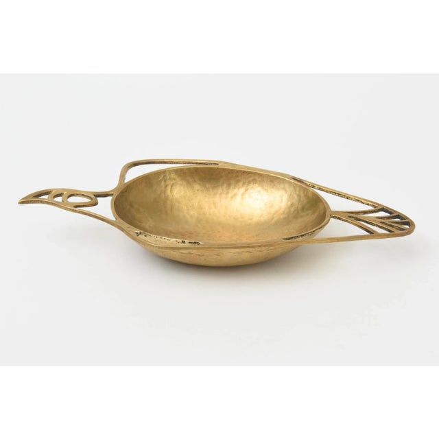 This vintage mid century modern hand hammered and hand wrought brass bowl is an abstract design of a bird. It is from the...